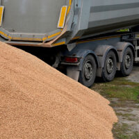 A Moving Floor Trailer In Front Of A Large Pile Of Gravel Belt Vs Walking Floor Trailer