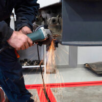 Closeup of a Mechanic Welding a Part During a Trailer Service Pinnacle Trailers’ After-Sales Service